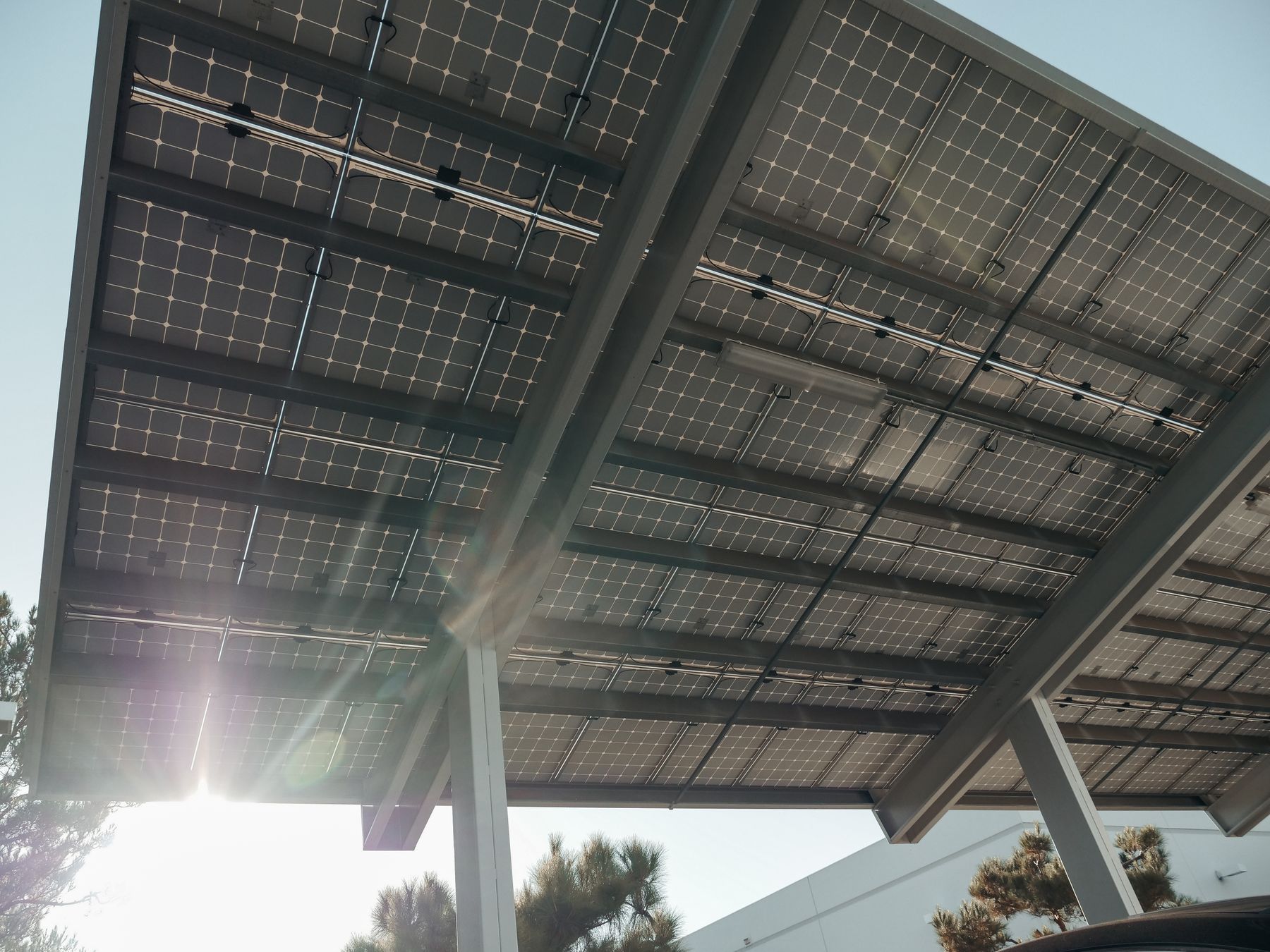 Solar panels catching bright sunlight on a metal mounting structure